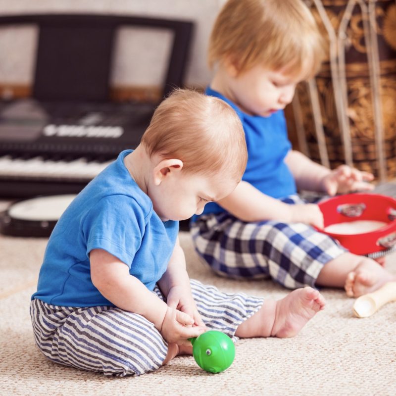 Small children playing with small musical instruments