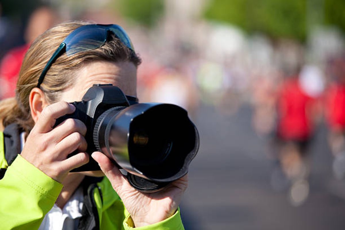 woman taking pictures outdoor of sports event